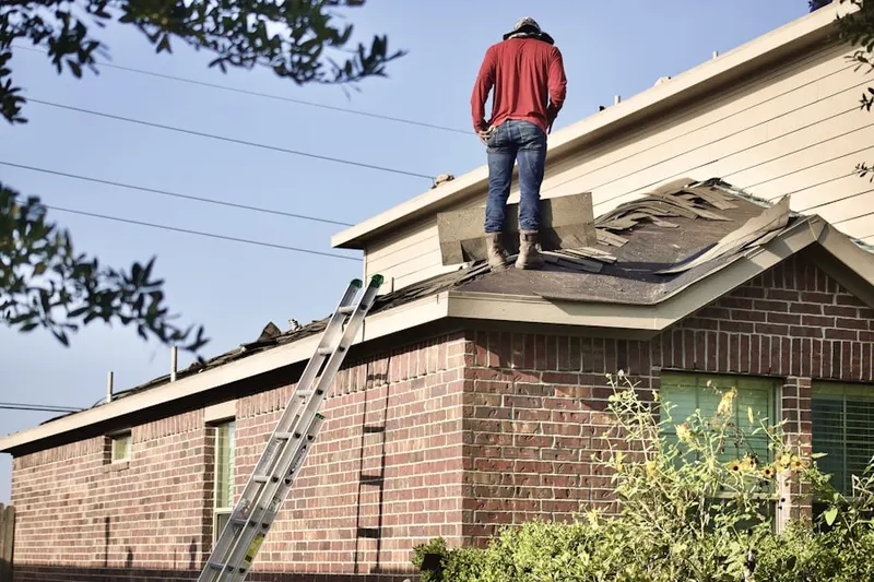 Professional roofer working on a residential roof in Olde Oaks